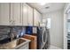 The laundry room has extra cabinets for storage and a utility sink at 14417 N 151St Dr, Surprise, AZ 85379