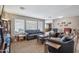 Comfortable living room with leather sofas, neutral tones, and bright natural light from the large windows at 14417 N 151St Dr, Surprise, AZ 85379
