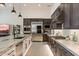 Modern kitchen featuring stainless steel appliances, stone countertops, and sleek dark wood cabinetry at 14551 N Adero Canyon Dr, Fountain Hills, AZ 85268