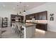 Spacious kitchen featuring an island with seating, stainless appliances, and dark wood cabinets at 14551 N Adero Canyon Dr, Fountain Hills, AZ 85268
