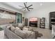 Comfortable living room features a large sectional sofa, fireplace, and sliding glass doors to the patio at 14551 N Adero Canyon Dr, Fountain Hills, AZ 85268