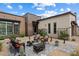 A cozy outdoor patio area with a fire pit, lounge chairs, and desert landscaping at 14551 N Adero Canyon Dr, Fountain Hills, AZ 85268