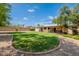 Expansive backyard showcasing a circular brick-lined border and mature trees, providing a private outdoor space at 14627 N 55Th Pl, Scottsdale, AZ 85254