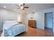 A bedroom with hardwood floors, a white bed frame, a ceiling fan, and a view of an arched doorway at 14627 N 55Th Pl, Scottsdale, AZ 85254