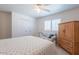 Spacious bedroom with a large built-in cabinet and large shuttered windows at 14627 N 55Th Pl, Scottsdale, AZ 85254