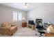Comfortable bedroom features a work space and a floral armchair at 14627 N 55Th Pl, Scottsdale, AZ 85254
