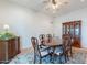 Elegant dining room with wood table, upholstered chairs, china cabinet, and decorative rug over tile floor at 14627 N 55Th Pl, Scottsdale, AZ 85254