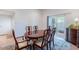 Dining room with wood table, six chairs, sliding doors to the patio, tile flooring and area rug at 14627 N 55Th Pl, Scottsdale, AZ 85254