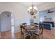 Dining room area with chandelier and wood table open to the living room at 14627 N 55Th Pl, Scottsdale, AZ 85254