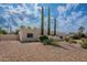Single-story home with desert landscaping, mature trees, blue trimmed window and two car garage at 14627 N 55Th Pl, Scottsdale, AZ 85254