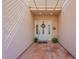Inviting front entrance with tiled walkway, decorative door with sidelights, and a covered pergola at 14627 N 55Th Pl, Scottsdale, AZ 85254