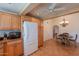 A kitchen featuring wood cabinets, stainless steel appliances, tile floors, and adjacent dining area at 14627 N 55Th Pl, Scottsdale, AZ 85254