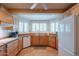 Charming kitchen with tile floors, wood cabinets, white appliances and natural light at 14627 N 55Th Pl, Scottsdale, AZ 85254