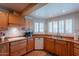 Charming kitchen with tile floors, wood cabinets, white appliances and natural light at 14627 N 55Th Pl, Scottsdale, AZ 85254