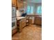 Charming kitchen with tile floors, wood cabinets, and updated appliances at 14627 N 55Th Pl, Scottsdale, AZ 85254