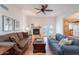 Well-lit living room boasts fireplace, neutral walls, earth-tone flooring and comfortable furnishings at 14627 N 55Th Pl, Scottsdale, AZ 85254