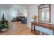 Inviting living room with earth tone tile floors, neutral walls, and updated wood console table at 14627 N 55Th Pl, Scottsdale, AZ 85254