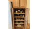 Organized pantry with pull-out shelves filled with various food items and storage containers at 14627 N 55Th Pl, Scottsdale, AZ 85254