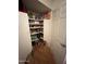 A walk-in pantry with shelves stocked with food, a fire extinguisher, and other household items at 14627 N 55Th Pl, Scottsdale, AZ 85254
