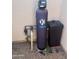 The water softener system is installed outdoors on gravel, enclosed with a gray cover; convenient and accessible at 14627 N 55Th Pl, Scottsdale, AZ 85254