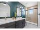 Stylish bathroom features a double vanity, a tiled shower, and modern fixtures at 1642 E Monte Vista Rd # 5, Phoenix, AZ 85006