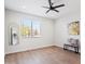 Spacious bedroom features a large window, wood floors, and a modern ceiling fan at 1642 E Monte Vista Rd # 5, Phoenix, AZ 85006