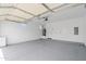 Spacious two-car garage with sealed floors, featuring a water heater, garage door opener and side door at 1642 E Monte Vista Rd # 5, Phoenix, AZ 85006