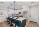 Modern kitchen with white cabinets, black accents, and a spacious quartz island with seating at 1642 E Monte Vista Rd # 5, Phoenix, AZ 85006