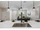 Open kitchen featuring bar seating, stylish lighting, and view of the adjacent living room at 1642 E Monte Vista Rd # 5, Phoenix, AZ 85006
