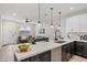 Bright kitchen with white countertops, dark cabinetry, and adjacent living room seating at 1642 E Monte Vista Rd # 5, Phoenix, AZ 85006