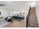 Open-concept living room featuring bar seating, stylish kitchen, and stairway at 1642 E Monte Vista Rd # 5, Phoenix, AZ 85006