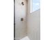 Close up of shower with tiled walls and a rain shower head and a bronze shower handle at 1642 E Monte Vista Rd # 5, Phoenix, AZ 85006