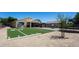 Beautiful backyard with custom artificial turf football field, patio area, and trampoline, perfect for outdoor fun at 18575 W Vogel Ave, Goodyear, AZ 85338