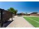 Spacious backyard with pavers, artificial turf, trampoline and outdoor seating area for relaxation and entertainment at 18575 W Vogel Ave, Goodyear, AZ 85338