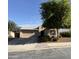 Charming single-story home featuring a desert landscape, covered front porch, and a two-car garage at 18575 W Vogel Ave, Goodyear, AZ 85338