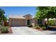Inviting single-story home with a tile roof, desert landscaping, and an attached garage at 18575 W Vogel Ave, Goodyear, AZ 85338