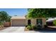 Charming single-story home featuring a well-manicured lawn and attached two-car garage at 18575 W Vogel Ave, Goodyear, AZ 85338