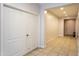 Bright hallway with tiled flooring, closet, and a view of the front door at 18575 W Vogel Ave, Goodyear, AZ 85338
