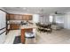Bright open-concept area featuring a kitchen, table and a sofa at 18575 W Vogel Ave, Goodyear, AZ 85338