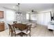Bright open-concept area featuring a kitchen, table and a sofa at 18575 W Vogel Ave, Goodyear, AZ 85338