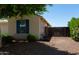 The side of the home with a gravel area, small trees and fencing at 18575 W Vogel Ave, Goodyear, AZ 85338