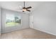 This bright bedroom features tile floors, a window, and a ceiling fan at 19601 N 7Th N St # 1072, Phoenix, AZ 85024