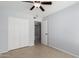This bedroom features tile flooring, a ceiling fan and a closet with paneled doors at 19601 N 7Th N St # 1072, Phoenix, AZ 85024