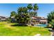 Scenic community view with mature trees, pool, and residential buildings at 19601 N 7Th N St # 1072, Phoenix, AZ 85024
