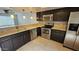 Kitchen featuring stainless steel appliances, neutral countertops, and dark wood cabinetry at 19601 N 7Th N St # 1072, Phoenix, AZ 85024