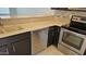Kitchen featuring stainless steel appliances, neutral countertops, and dark cabinets at 19601 N 7Th N St # 1072, Phoenix, AZ 85024