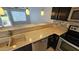 Kitchen with a dual basin sink, stainless steel appliances, neutral color countertops, and dark cabinets at 19601 N 7Th N St # 1072, Phoenix, AZ 85024