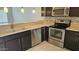 Modern kitchen features stainless steel appliances, dark wood cabinets and neutral color countertops at 19601 N 7Th N St # 1072, Phoenix, AZ 85024