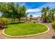 Expansive backyard with lush lawn, mature trees, and a sparkling pool in a desirable outdoor setting at 198 N Pecan Ct, Gilbert, AZ 85234