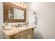 The bathroom features a vanity with a decorative mirror and a granite countertop at 198 N Pecan Ct, Gilbert, AZ 85234